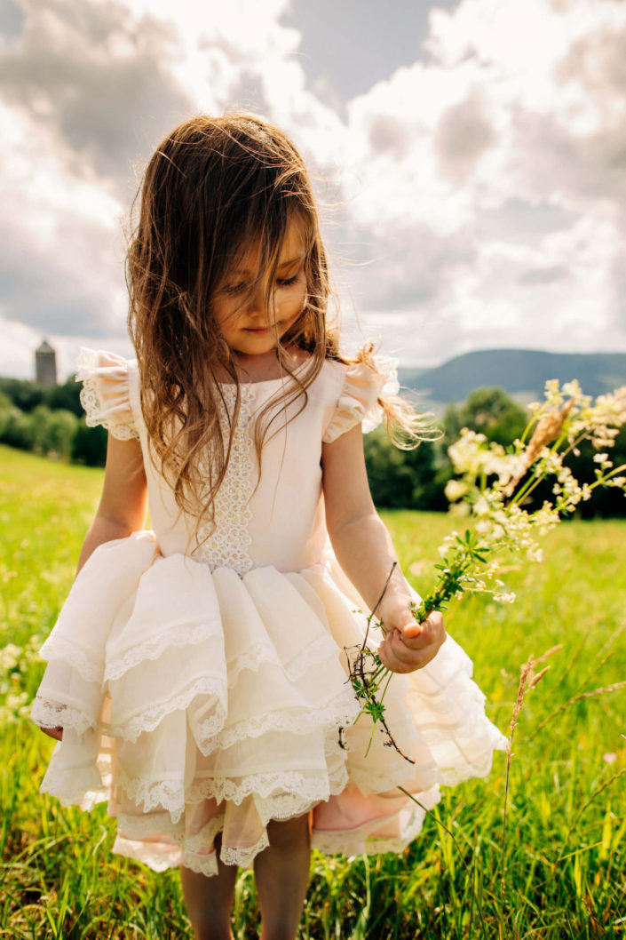 Little girl holding a bouquet of wildflowers